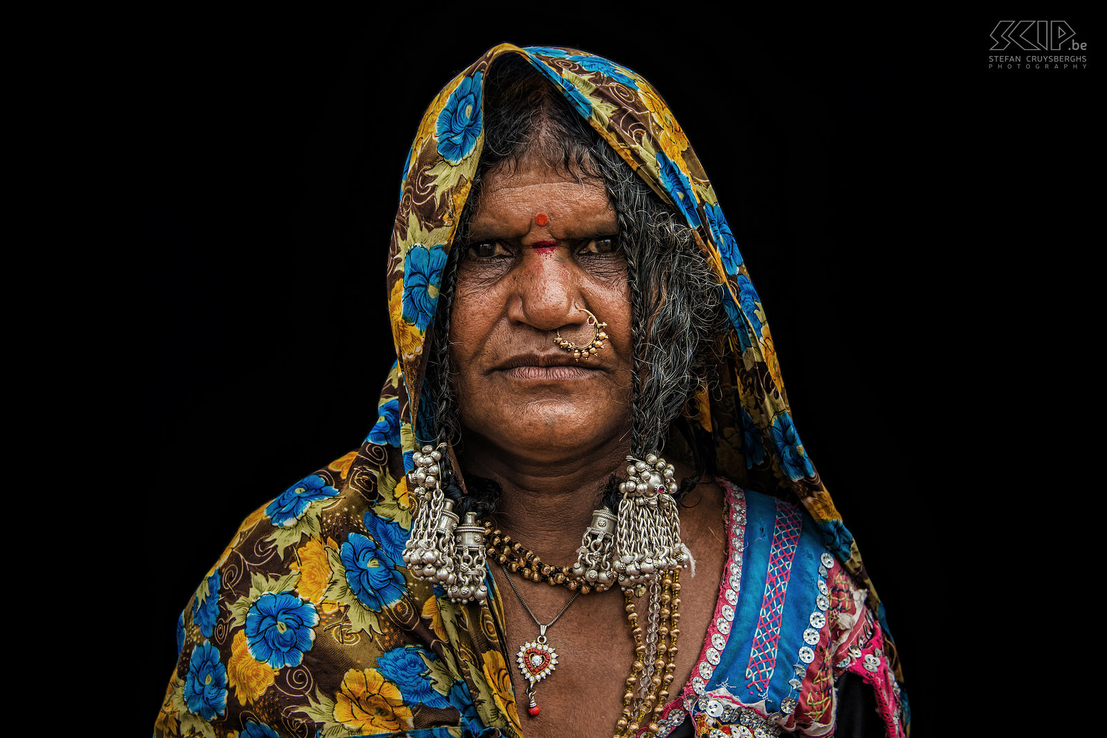 Banjara woman The Banjara or Lambani are nomadic are the largest gypsy group in India. The women make intricately embroidered colourful clothes with pieces of mirror, decorative beads and old coins.  They also wear ornate jewellery and some of them have tattoos. I photographed some Banjara women on different locations in the state of Karnataka in southern India. Stefan Cruysberghs